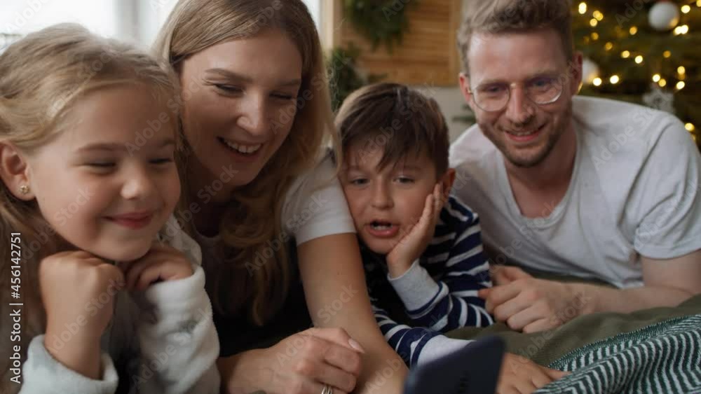 Family using smartphone during the Christmas. Shot with RED helium camera in 8K Family using smartphone during the Christmas. Shot with RED helium camera in 8K