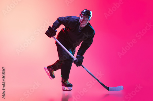 Photography Full-length studio shot of man, professional hockey player in motion isolted ove