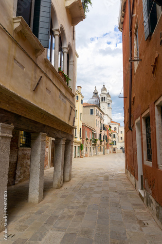 The small streets of Venice with a bell tower in the background