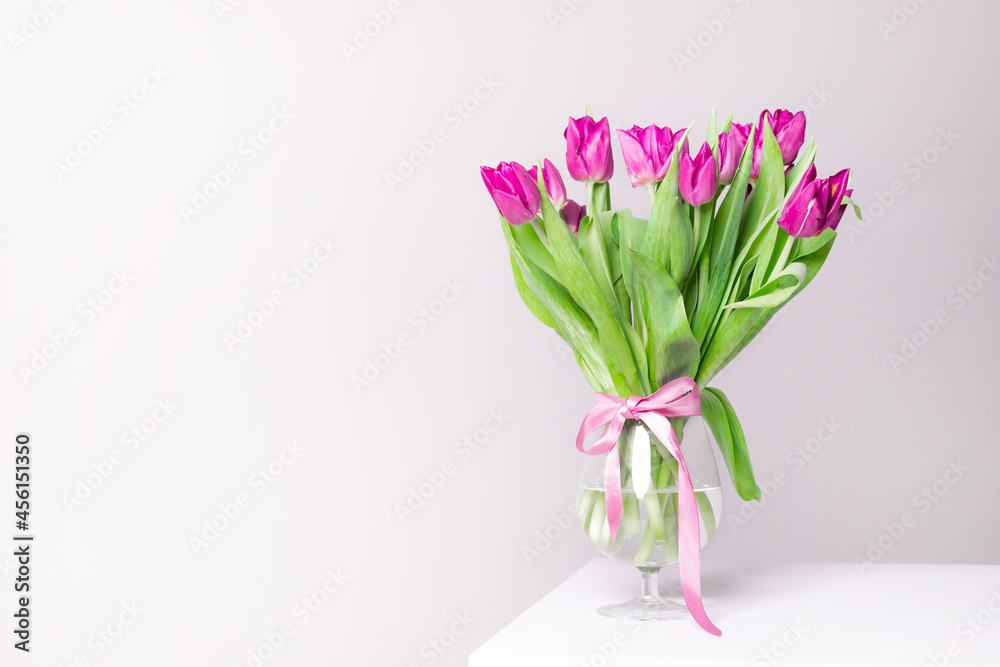A bouquet of lilac tulips in a vase . Bouquet of tulips. Flowers in a vase. A greeting card. Valentine's day. March 8. Mother's Day. Copy space
