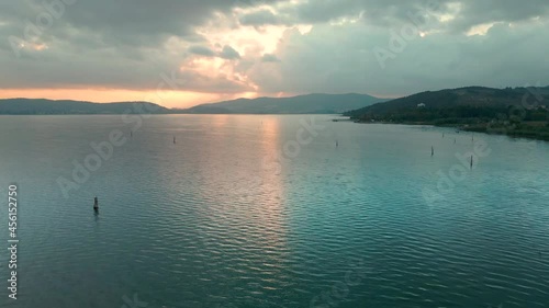 Tranquil Scenery Of Trasimeno Lake At Sunrise In Umbria, Italy - aerial drone shot photo