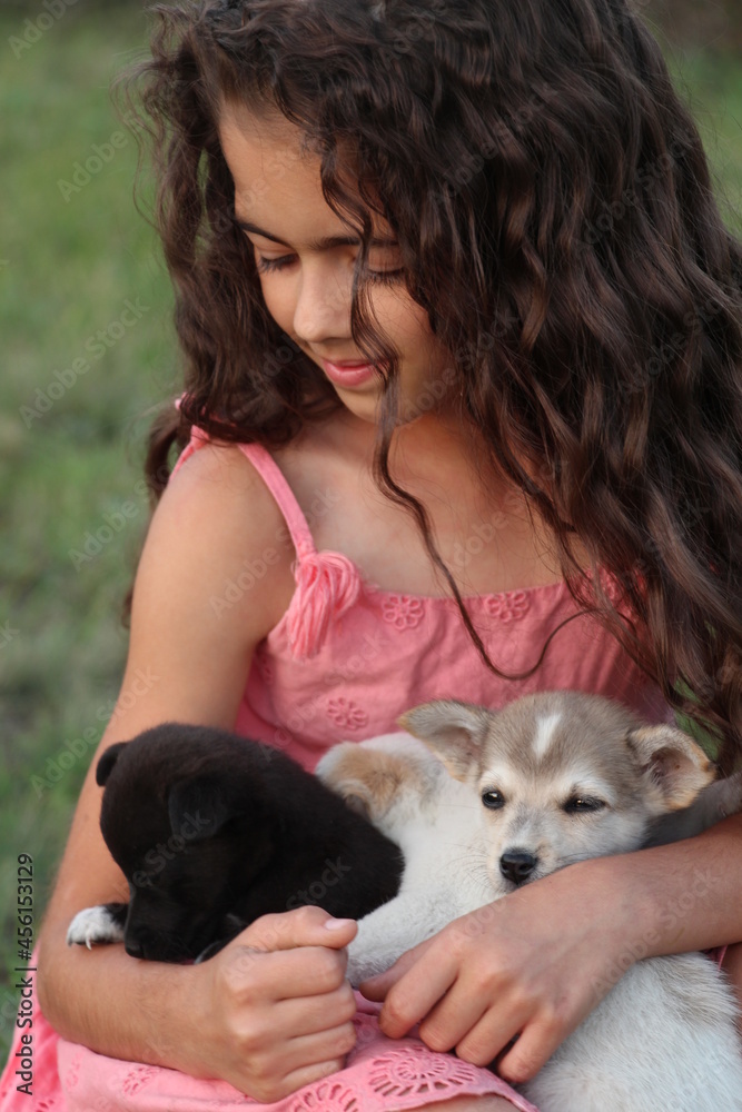 Obraz premium Beautiful girl with cute puppy