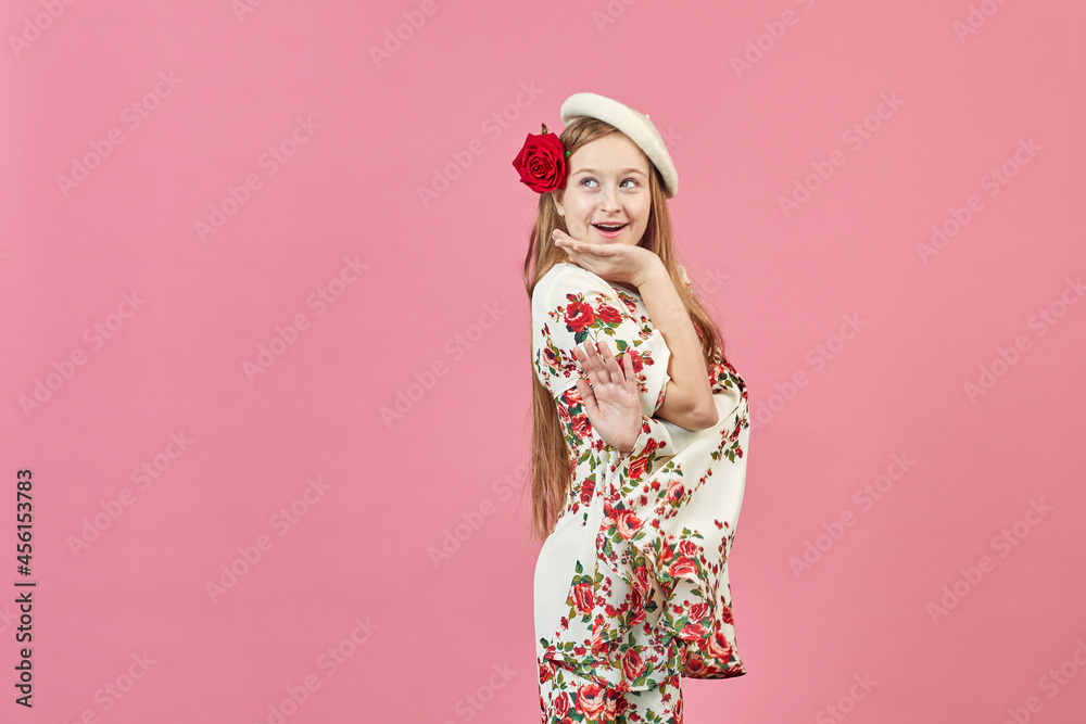 Fashion portrait of a beautiful elegant girl in a pretty dress with flowers on pink background. Young blonde woman in nice spring dress. Fashion spring summer concept. Fashion portrait of a beautiful elegant girl in a pretty dress with flowers on pink background. Young blonde woman in nice spring dress. Fashion spring summer concept.
