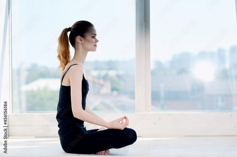 woman sitting in lotus position meditation rest near window woman sitting in lotus position meditation rest near window