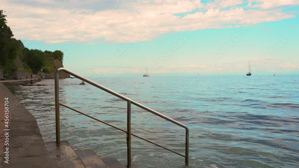 Almost empty San Simon Bay in Slovenia. Summer day without tourists. Beautiful Adriatic Sea and the boats. Static shot, real time Almost empty San Simon Bay in Slovenia. Summer day without tourists. Beautiful Adriatic Sea and the boats. Static shot, real time