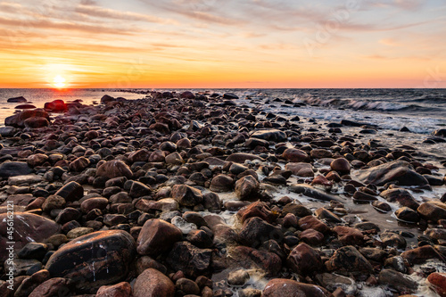 Sunset on the rock pier. Sunset over the rocky sea. Golden sunset at windy evening at rock pier where one side is calm and other side waves at Tahkuna, Hiiumaa, Estonia.  © Evelyn