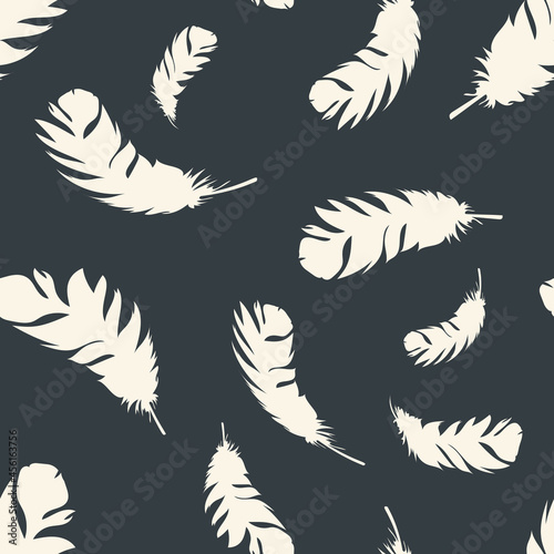 Bird light feathers fly on a dark background. Seamless pattern for modern fabrics, trendy textiles, decorative pillows. Vector.