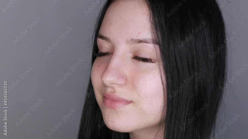 Young beautiful woman model posing in front of the camera. Girl with big lips and extended eyelashes and brown eyes without makeup Young beautiful woman model posing in front of the camera. Girl with big lips and extended eyelashes and brown eyes without makeup