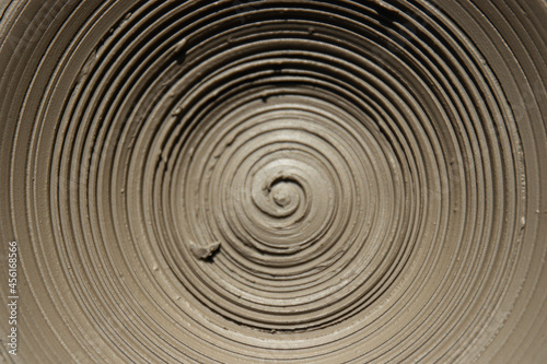 Spiral. A clay pot that has just been made by the potter. 
details