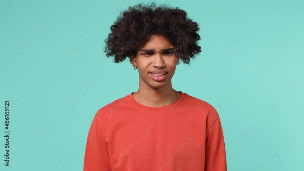 Young curly african american man 20s wears azure t-shirt look camera pointing fingers himself ask say who me no thank i do not need it isolated on plain pastel light blue background studio portrait Young curly african american man 20s wears azure t-shirt look camera pointing fingers himself ask say who me no thank i do not need it isolated on plain pastel light blue background studio portrait