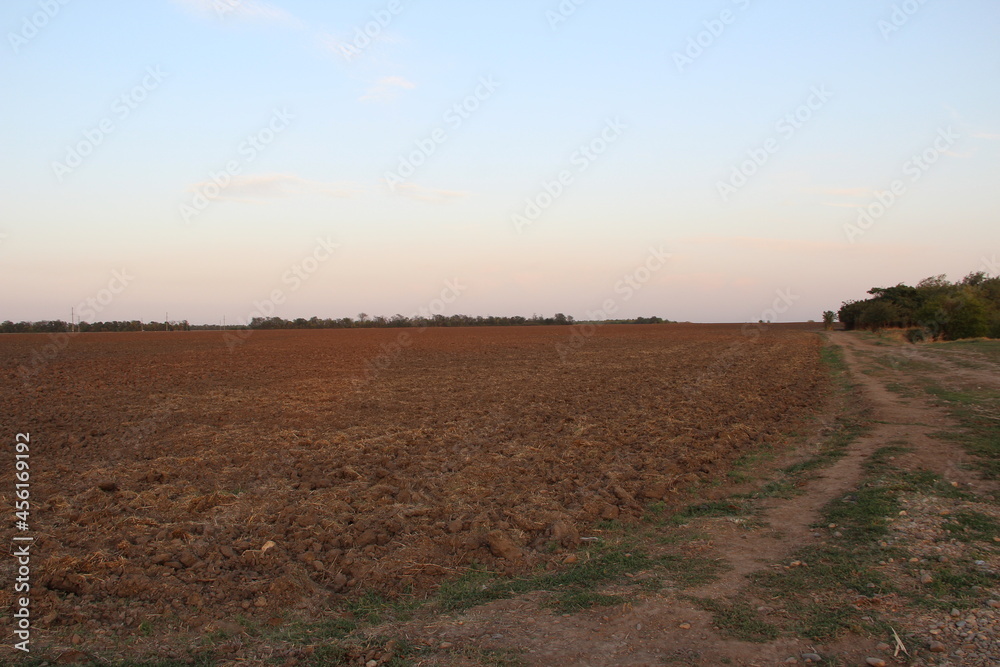 Plowed agricultural field at the evening Plowed agricultural field at the evening