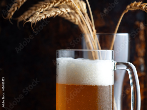 A mug of cold wheat beer, wheat ears in a beer glass