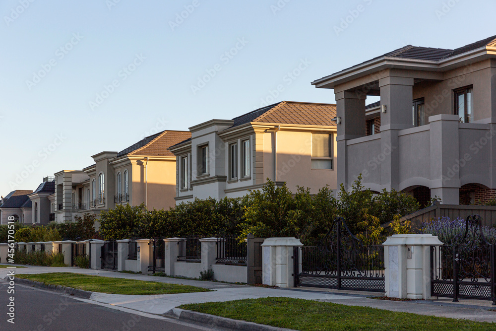 Modern estates behind fences in suburb.