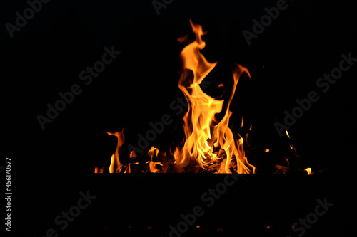 flames at night. Fire flames on black background.  tongues of flame on the background of coals