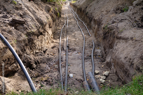 Laying plumbing  pipes and electrical cables in the ground. The cable is laid in the ground. City communications. ..