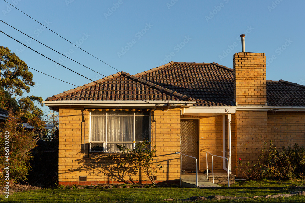 Fototapeta premium Cozy brick cottage in suburb.