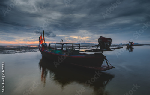 Fishery wooden boat with sunset sky low lighting.