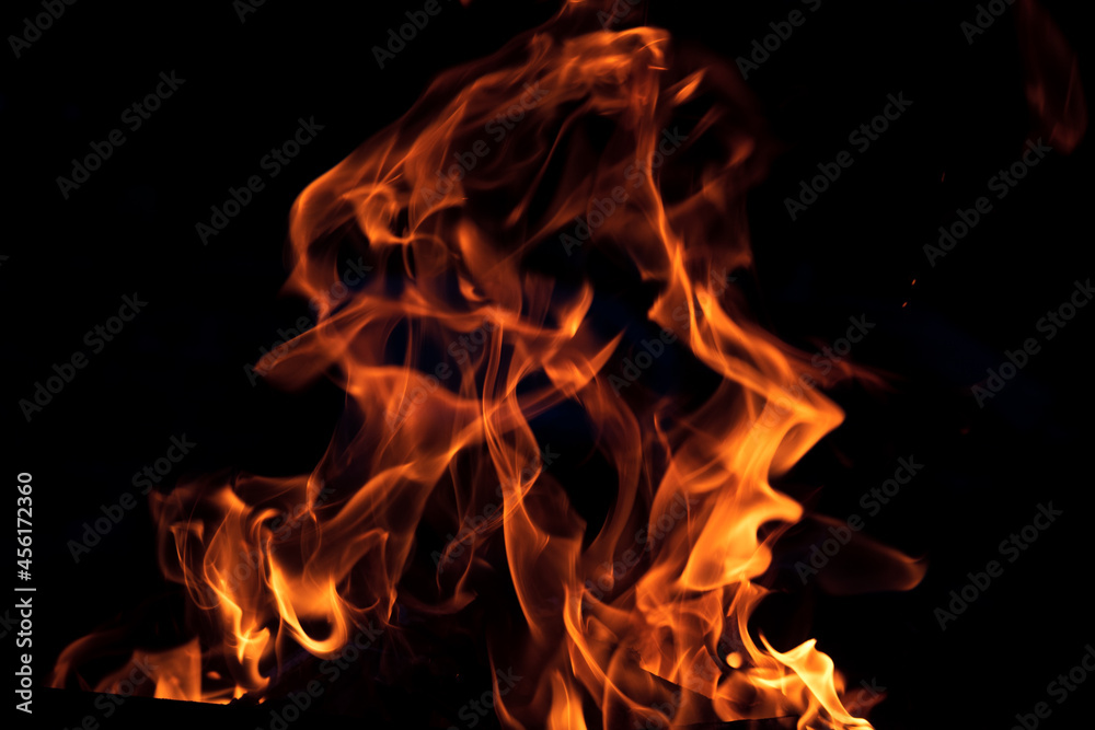 Orange flame on black background. Heat energy heap closely, red and yellow Orange flame on black background. Heat energy heap closely, red and yellow