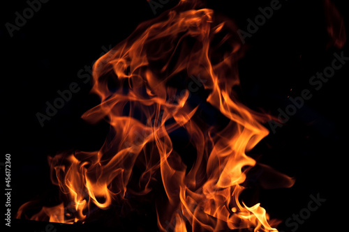 Orange flame on black background. Heat energy heap closely  red and yellow