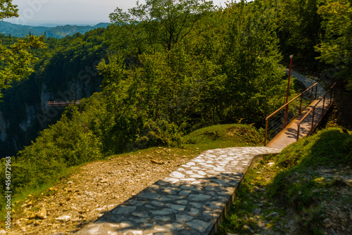 OKATSE, GEORGIA: A beautiful scenic road that leads to Okatse Canyon on a sunny summer day. photo