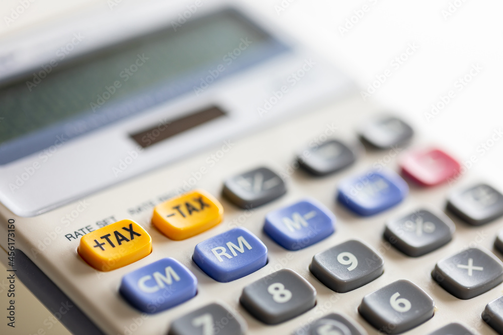 Selective focus on plus tax yellow button of calculator. Selective focus on plus tax yellow button of calculator.