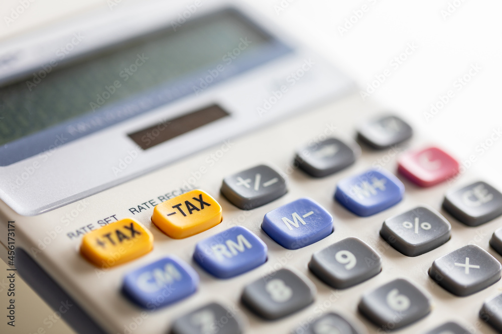 Selective focus on minus tax yellow button of calculator. Selective focus on minus tax yellow button of calculator.