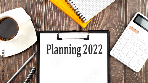 PLANNING 2022 text on paper with coffee  calculator and notebook. Business concept