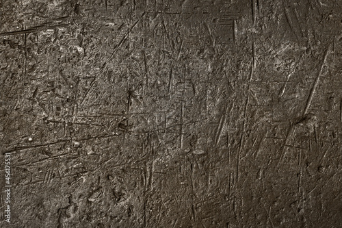 Rough metal surface with scratches and dents.