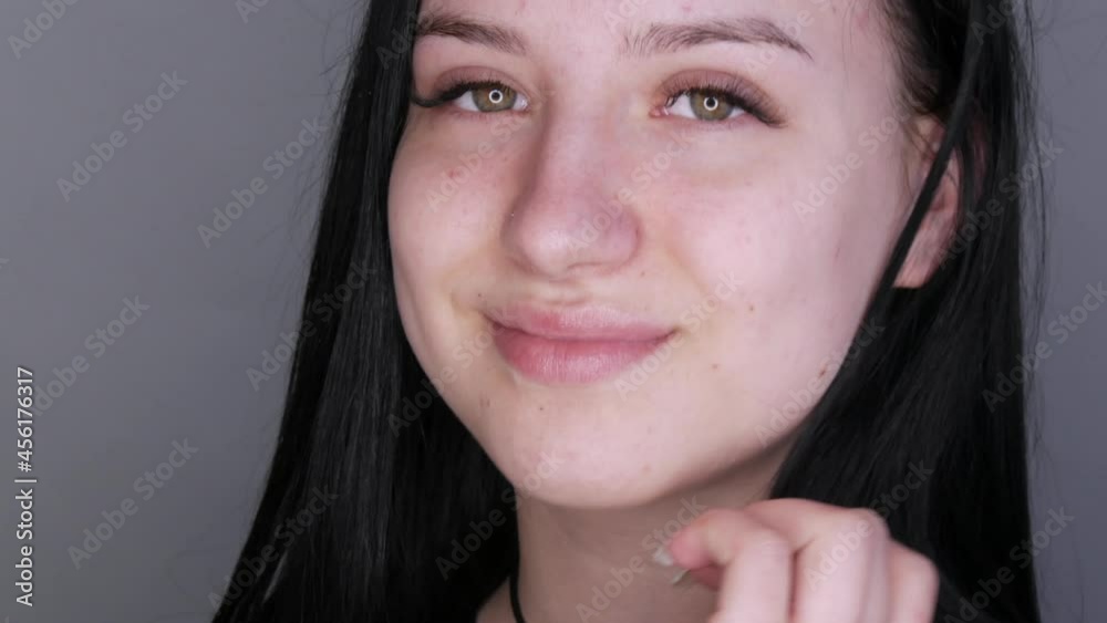 Young beautiful woman model posing in front of the camera. Girl with big lips and extended eyelashes and brown eyes without makeup Young beautiful woman model posing in front of the camera. Girl with big lips and extended eyelashes and brown eyes without makeup