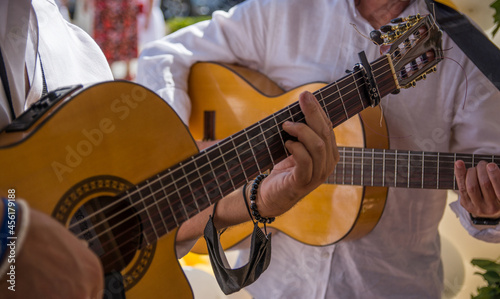 Close-up Of A Man's Hands Playing The Spanish Guitar. Anonymous Man Making Music With A Spanish Guitar. Music Concept