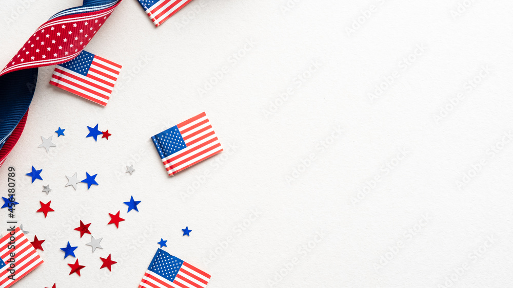 Obraz premium Columbus Day card, poster, background. Flat lay composition with United states decorations and ribbon on white background.
