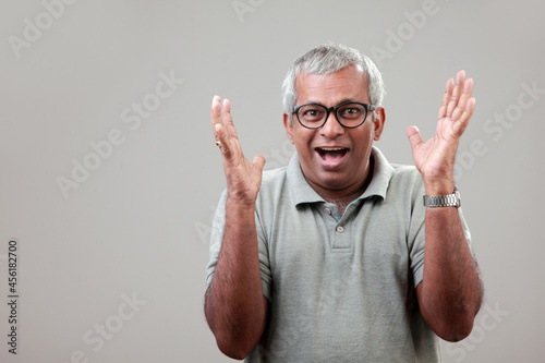 Mature man of Indian ethnicity with a cheering expression photo