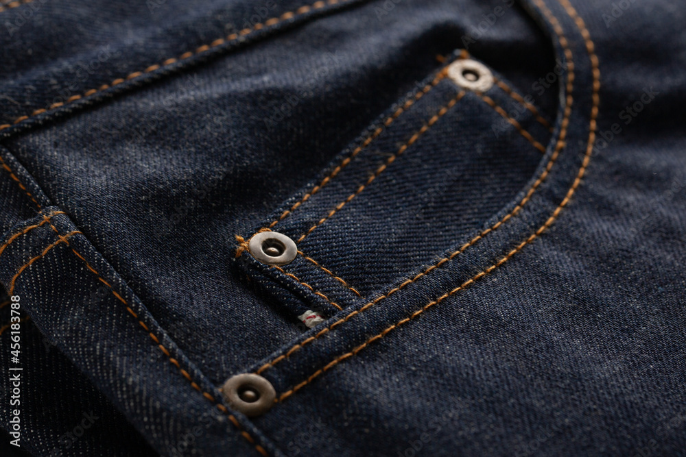 Textile of classic blue jeans with pocket close up.