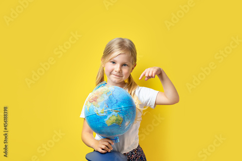 girl showing finger yellow background