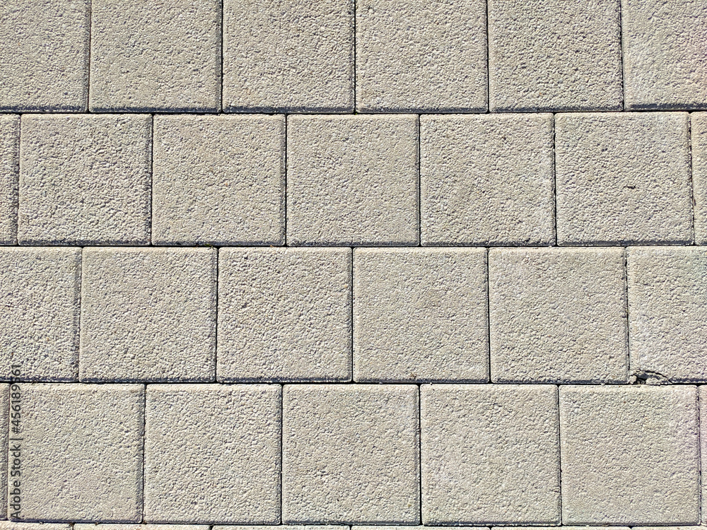 Fototapeta premium Background and texture of gray color from square paving slabs. Pedestrian street decor.