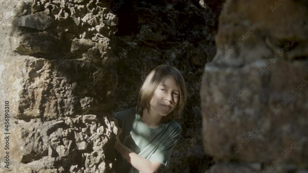 Pensive fair-haired boy standing in fortress. Caucasian male person spending summer vacation exploring old mansion, travelling across Europe. Derelict castle, exploration concept Pensive fair-haired boy standing in fortress. Caucasian male person spending summer vacation exploring old mansion, travelling across Europe. Derelict castle, exploration concept