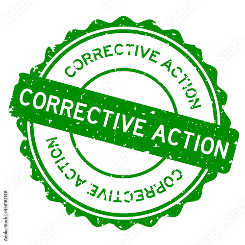 Grunge green corrective action word round rubber seal stamp on white background