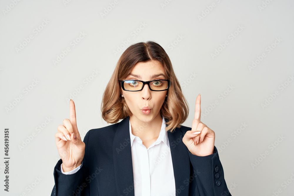 Businesswoman gestures with his hands light background emotions Businesswoman gestures with his hands light background emotions
