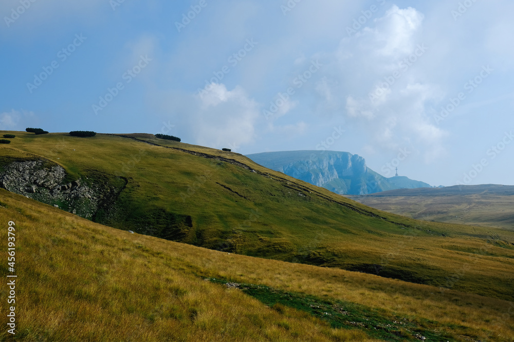 Amazing landscape on the Bucegi Plateau, the road from Piatra Arsa to  Babele, Carpathian Mountains, Romania. Far away is Caraiman  Heroes' Cross.