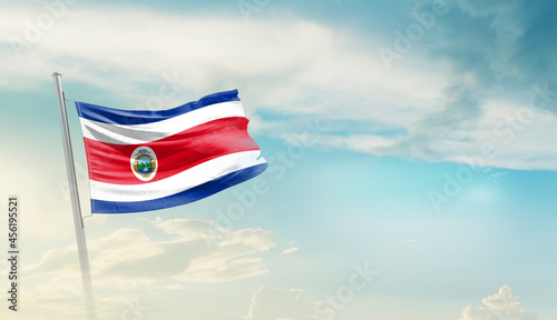 Costa Rica national flag cloth fabric waving on the sky with beautiful sun light - Image