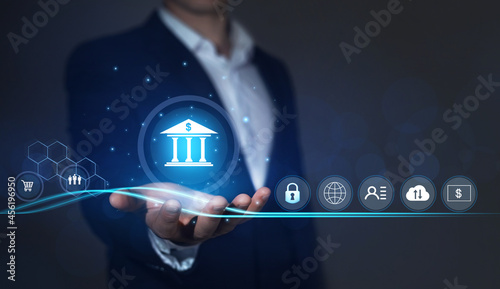  Bank safety and protection of personal and financial data. Businessman holding online banking icons and network connection icons. Digital technology business.