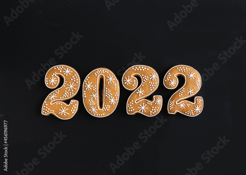 Gingerbread cookies in the form of numbers, gingerbread New Year 2022 on white wood background
