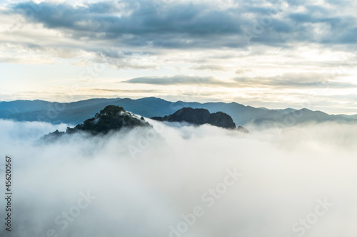 Magnificent heavy the sea of mist to cover top of mountain among sunrise at countryside  Vang Vieng  Laos 