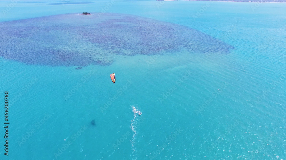 Aerial view of kitesurfing extreme sport with the wind freestyle. Beautiful top view of nice beach.