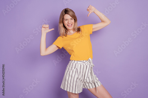 Photo of young attractive woman happy positive smile poitn thumb herself proud victory isolated over violet color background