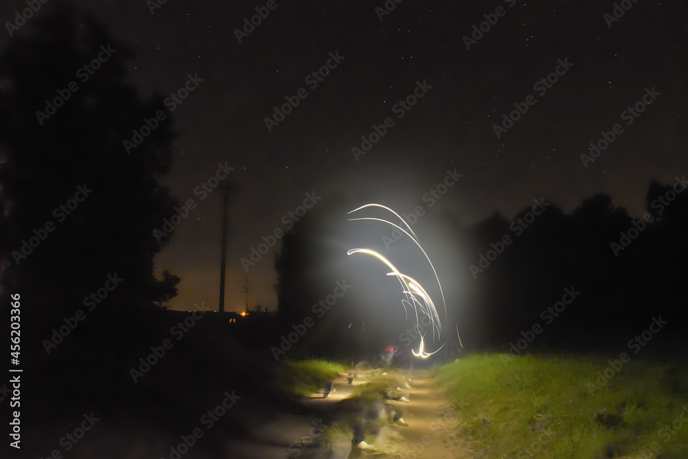 Luminous abstract image, painting with light on a warm spring night, landscape