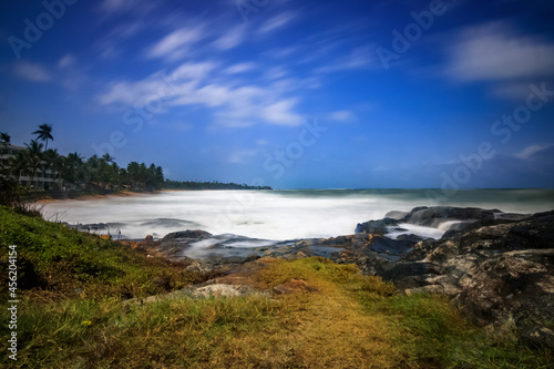 The coast of Sri Lanka  with stones in the foreground. Sunset on the sand beach. sea