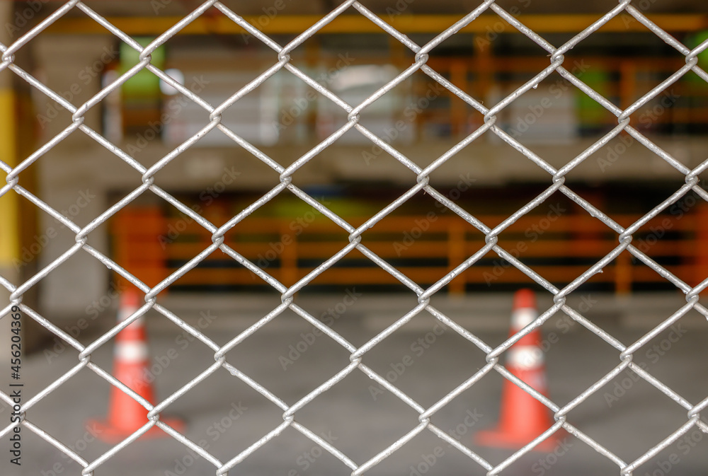 Fototapeta premium Steel metal fence with traffic cone background