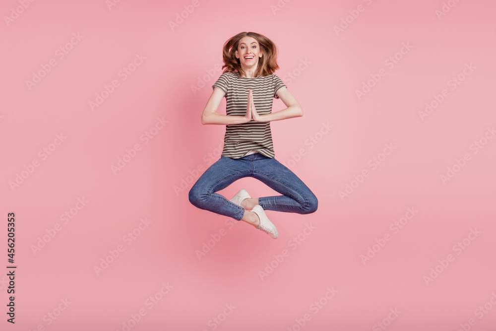 Full size photo of young woman happy positive smile ask wish dream please wait gift excited jump isolated over pink color background Full size photo of young woman happy positive smile ask wish dream please wait gift excited jump isolated over pink color background