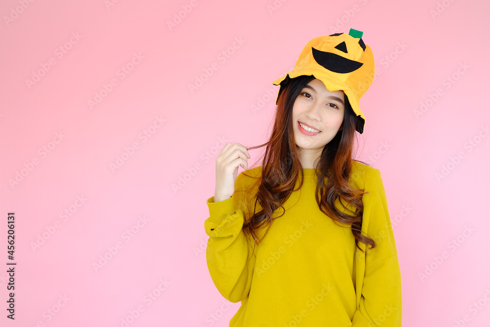 portrait asian cute girl wearing casual clothes with halloween hat posing, holiday halloween concept on pink background portrait asian cute girl wearing casual clothes with halloween hat posing, holiday halloween concept on pink background